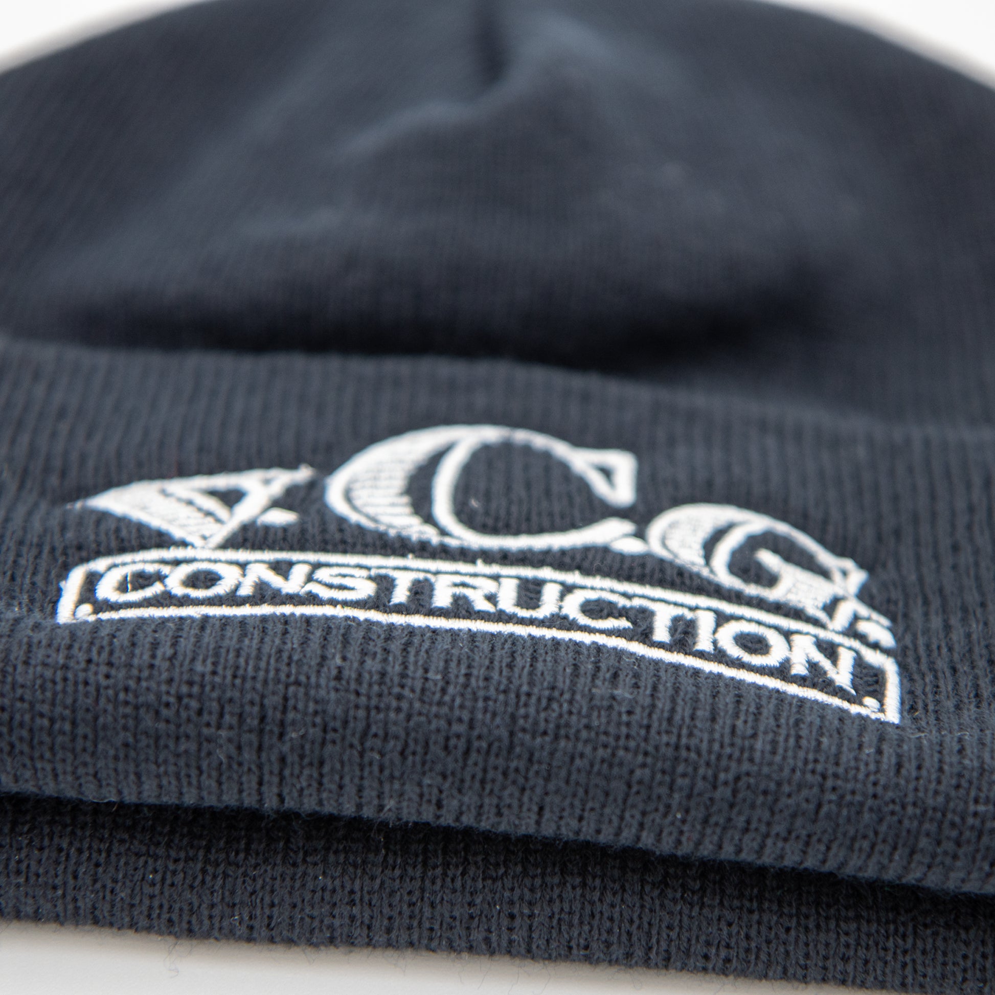 VCG Construction black knit beanie with embroidered logo layed flat
