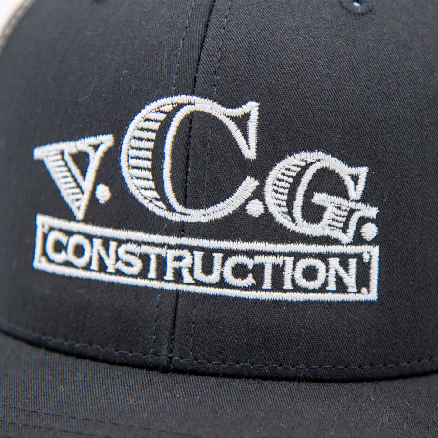 Close-up of VCG Construction embroidered logo on snapback hat