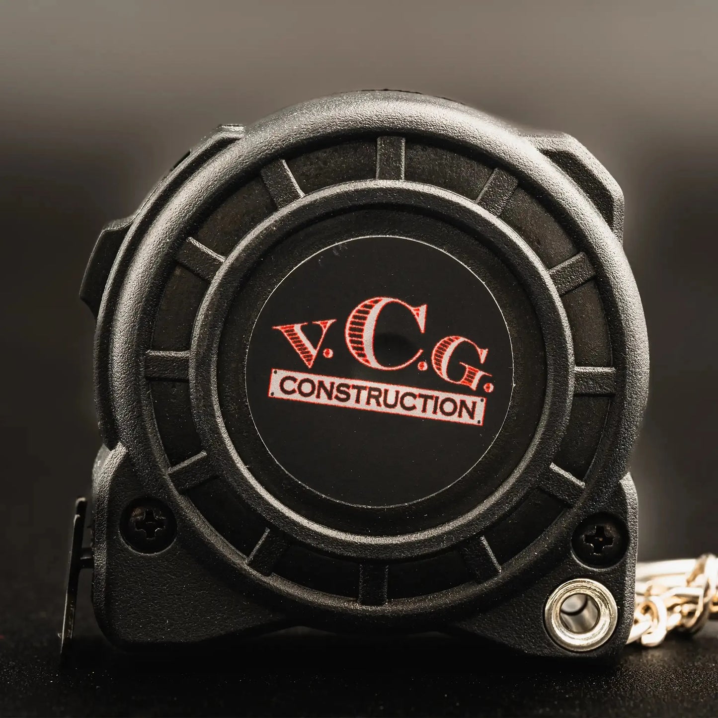 Compact and precise 1/2in x 8' Shockforce Nite Eye Tape Measure Key Chain featuring the VCG Construction logo – a portable tool for accurate measurements on the go