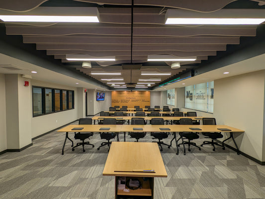 "Spacious, modern interior of the John M Connolly Center at Ss. Neumann Goretti High School featuring premium furnishings, advanced audio-visual technology, and contemporary ceiling design by VCG Construction."