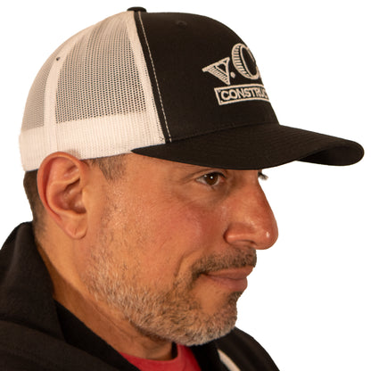 Right side view of VCG Construction black and white snapback hat on model