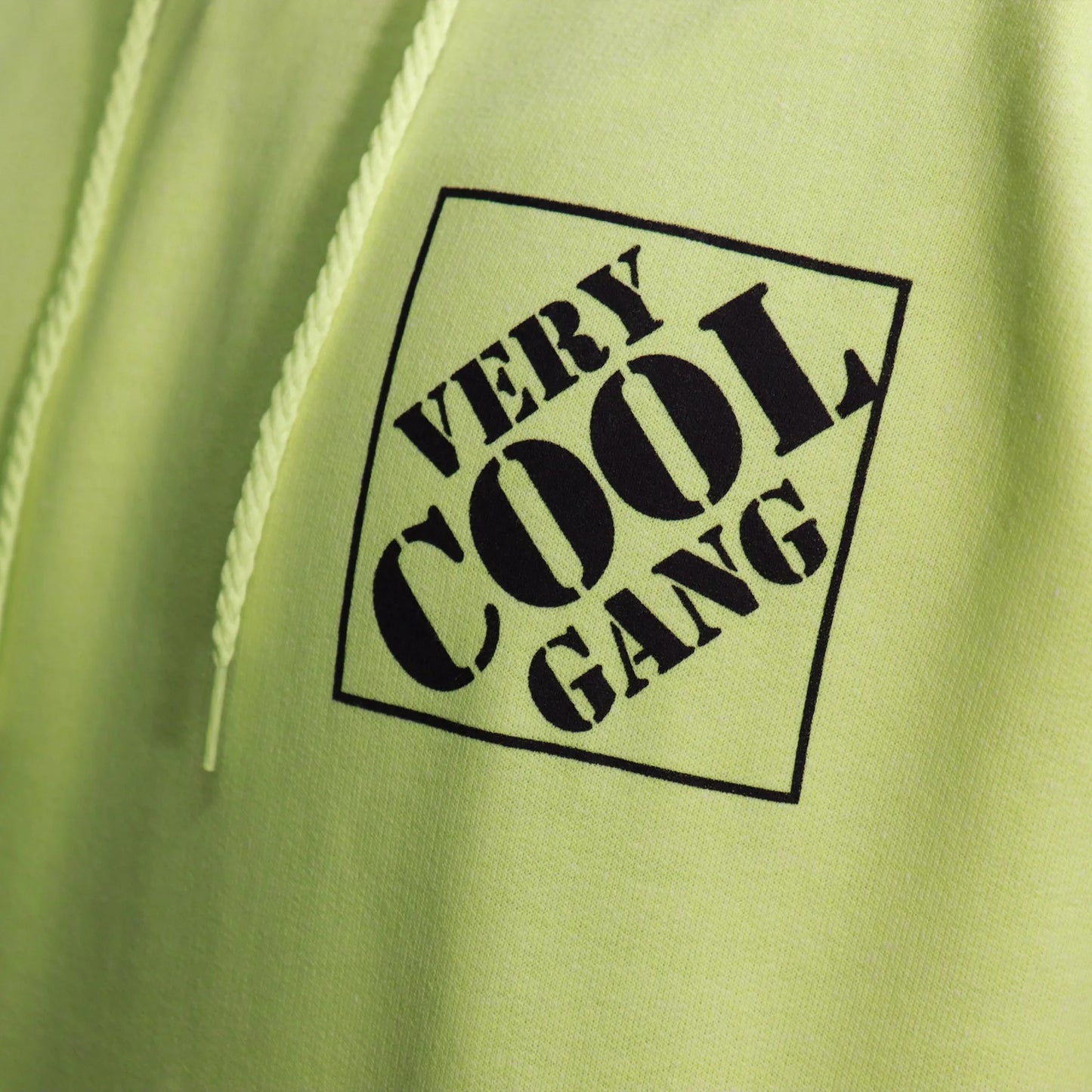 Logo screen printed in black from VCG Tool Deals adorns the left chest of a vibrant Hi-Viz Green safety Hoodie, providing warmth and visibility,